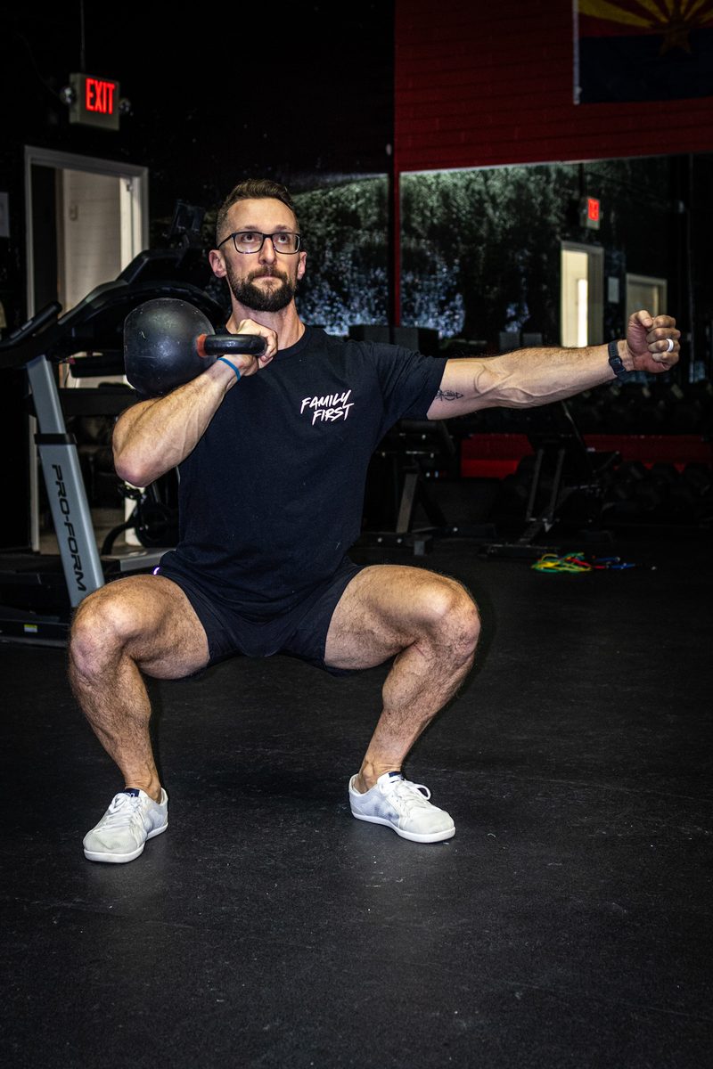 David performing a kettlebell squat