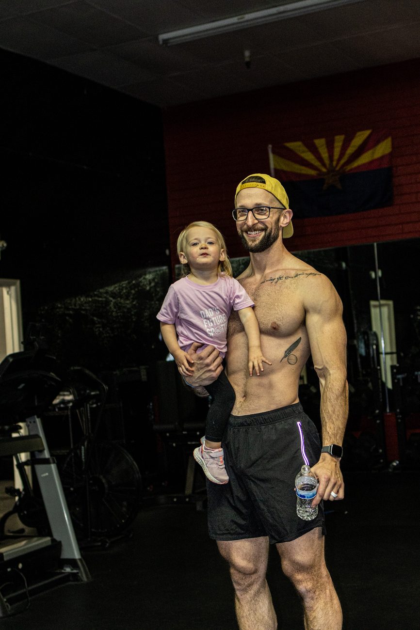David smiling with his daughter in the gym